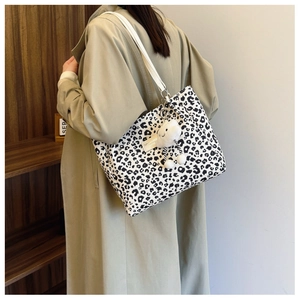 Detail of leopard print tote bag with white strap and cute cloud plush charm