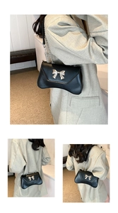 Close-up of black crossbody bag featuring a distinctive silver metal butterfly bow detail