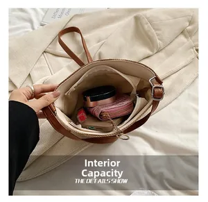 Detail of hand-held straw bucket bag showing inner capacity for mobile and makeup items