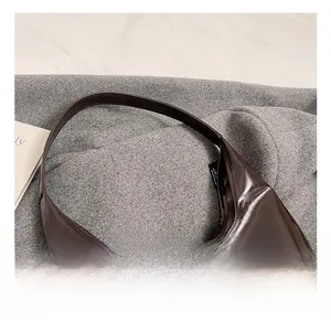 Close-up of the comfortable glossy dark coffee tote bag handle with polished finish