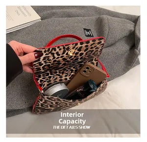 Internal capacity of leopard print handbag showing space for phone and makeup