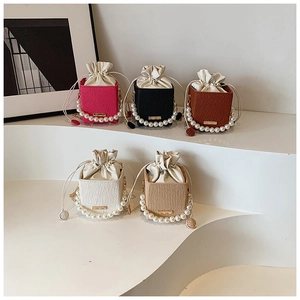 Mini pearl handle bucket bags shown in pink, black, brown, white and beige colors