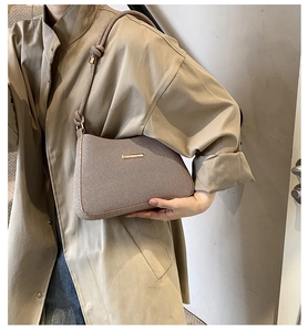 Detail of soft twill fabric texture and rope shoulder strap with gold metal buckle