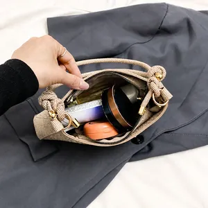 Interior view of brown woven hobo bag showing spacious main compartment for cosmetics