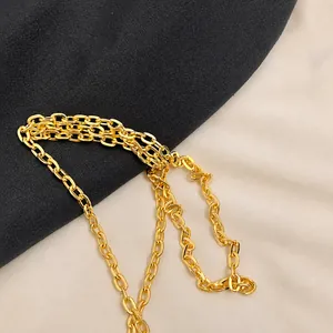 Close-up of high-quality golden metal chain strap with polished oval links for handbags