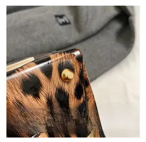 Close-up of leopard print bucket bag base with protective golden metal feet
