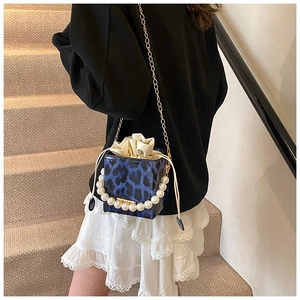 Blue leopard print square bag detail with large pearl handle and metal chain shoulder strap