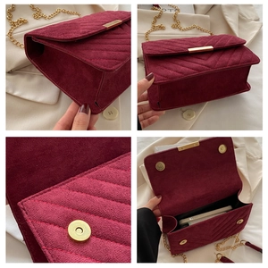 Detail view of burgundy chevron quilted bag with gold chain strap and magnetic closure