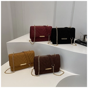 Detail view of four V-quilted chain bags in burgundy, black, yellow, and coffee brown