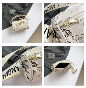 Detail of cylinder crossbody bag with vintage prints, wide strap and gold hardware