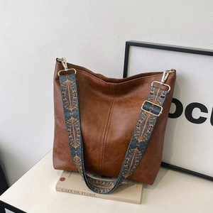Vintage brown hobo tote bag with embroidered wide strap and premium leather texture