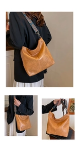 Close-up of brown PU leather tote with colorful ethnic embroidery wide strap and gold hooks