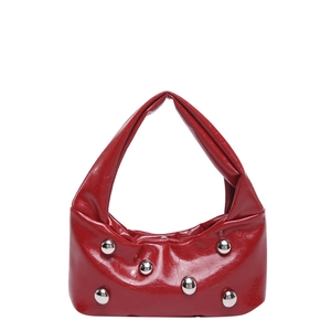 Red glossy crescent handbag with silver metal studs and unique pointed single handle design