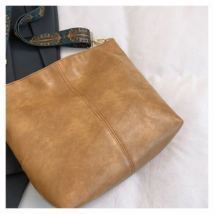 Detail of retro brown tote bag with bohemian pattern wide fabric shoulder strap