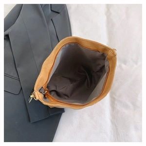 Interior view of large brown tote bag showing gray lining and secure metal zipper detail