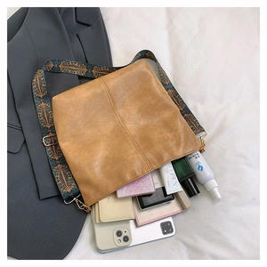Interior view of brown leather tote showing capacity for phone, wallet and cosmetics