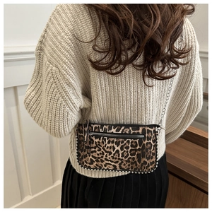 Detailed view of leopard print shoulder bag with silver studs and thin chain strap