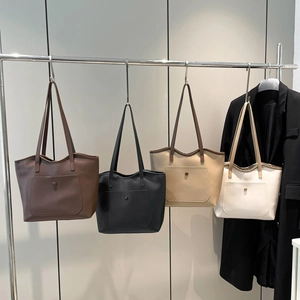 Minimalist large-capacity tote bags for women in four chic colors on a metal hanger