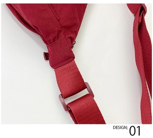 Detailed view of the dark red canvas bag strap connection and plastic adjustable buckle