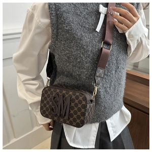 Detail of vintage brown monogram camera bag with adjustable wide nylon shoulder strap