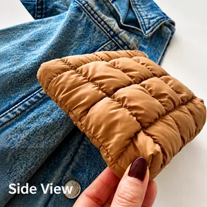 Side view of caramel brown quilted puffer bag with plush padded texture details