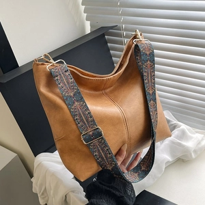 Close-up of caramel brown tote bag featuring a bohemian embroidered wide shoulder strap