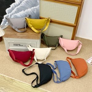 Minimalist solid color nylon dumpling bags in nine colors with adjustable straps