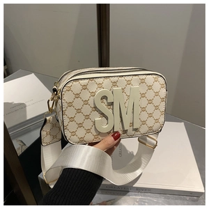 Detail of crossbody bag with monogram pattern, 3D letters and adjustable wide strap