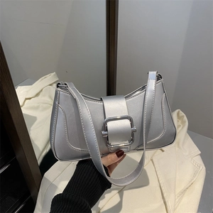 Metallic silver baguette shoulder bag with large metal buckle and minimalist urban design