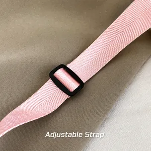 Detailed view of pink woven shoulder strap with adjustable buckle for crossbody bags
