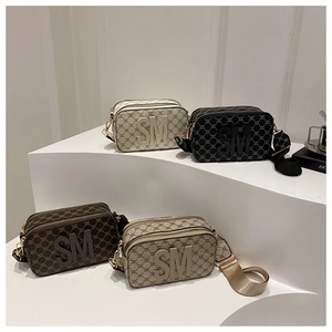 Detailed collection of mini monogram crossbody camera bags with SM logo on tiered stands