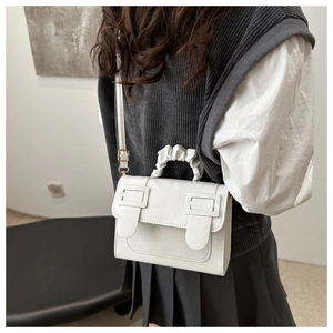Détail du sac blanc en cuir avec poignée froncée en nuage et boucles doubles