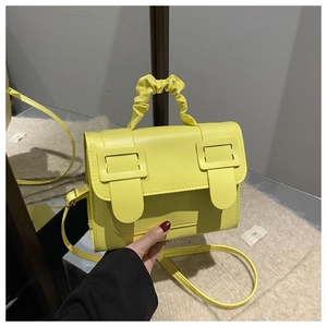 Détail du petit sac jaune en cuir PU avec poignée froncée et boucle carrée élégante