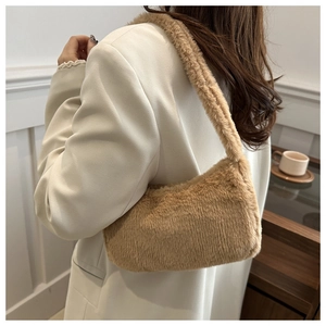 Chic fluffy camel faux fur shoulder bag worn by model in a minimalist interior setting