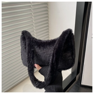 Close-up of black faux fur shoulder bag featuring soft plush texture and curved handle