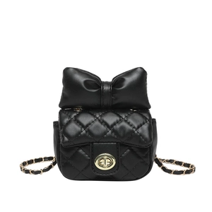 Mini black quilted crossbody bag with large leather bow and golden chain strap
