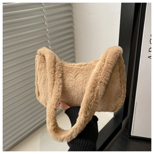 Detail showing plush camel faux fur texture on a soft shoulder bag with wide strap