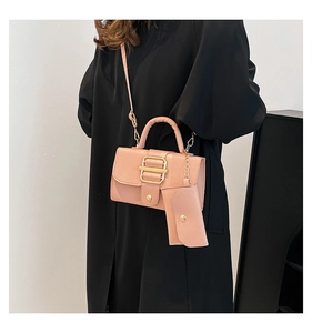 Detail of pink lychee pattern crossbody bag with golden buckle and mini coin pouch
