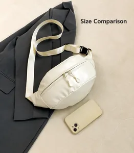 Detailed view of the white crossbody waist bag size compared to a smartphone