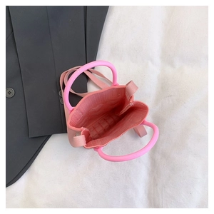 Top view of pink knit mini bag showing spacious interior and round plastic handles