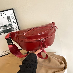 Minimalist deep red crossbody bag with dual zippers and adjustable nylon strap