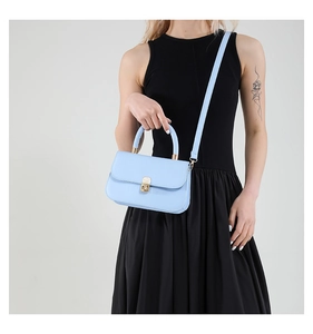 Light blue structured crossbody bag with gold buckle and adjustable shoulder strap