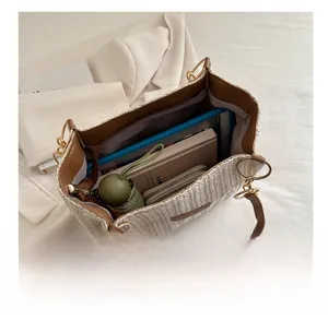 Interior view showing the large capacity of the woven tote bag with daily essentials