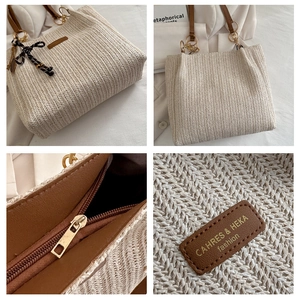 Close-up of woven straw tote bag with brown leather straps and dotted silk ribbon detail