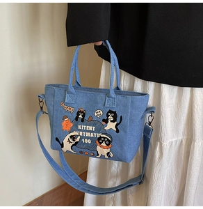 Detail of cartoon denim tote bag with cute cat prints and adjustable wide shoulder strap