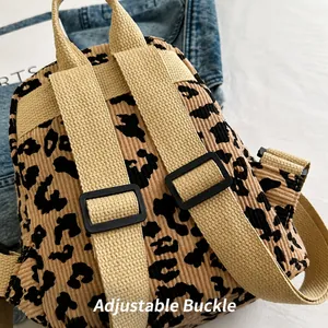 Close-up of adjustable strap buckle on leopard print backpack with durable webbing detail