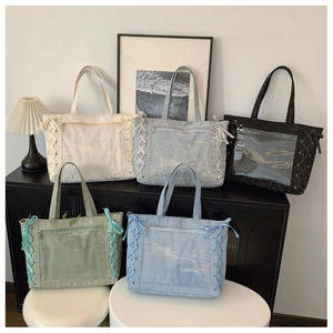 Detail of colorful tote bags with clear PVC pockets and stylish side ribbon accents