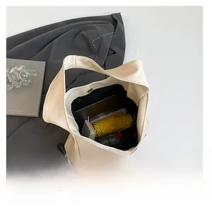 Top view of cream large shoulder bag showing capacity for tablet, umbrella and phone