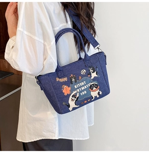Detail of cartoon denim tote bag with adjustable shoulder straps and cute character prints