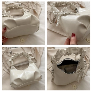 Detailed views of a white pleated crossbody bag featuring pearl bow and chain strap